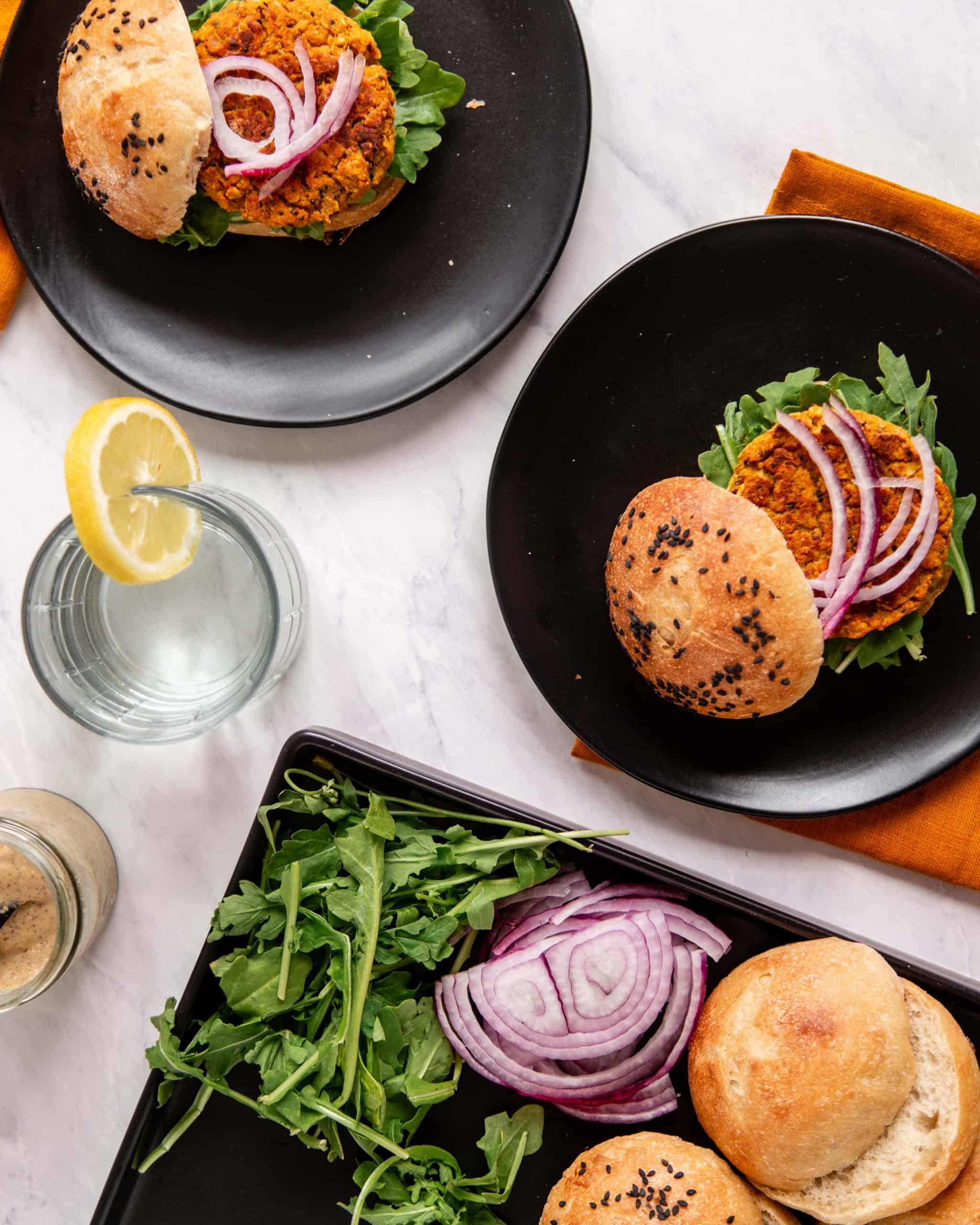 Veggie Burgers with Turmeric Chickpeas and Sweet Potato on a white surface. 