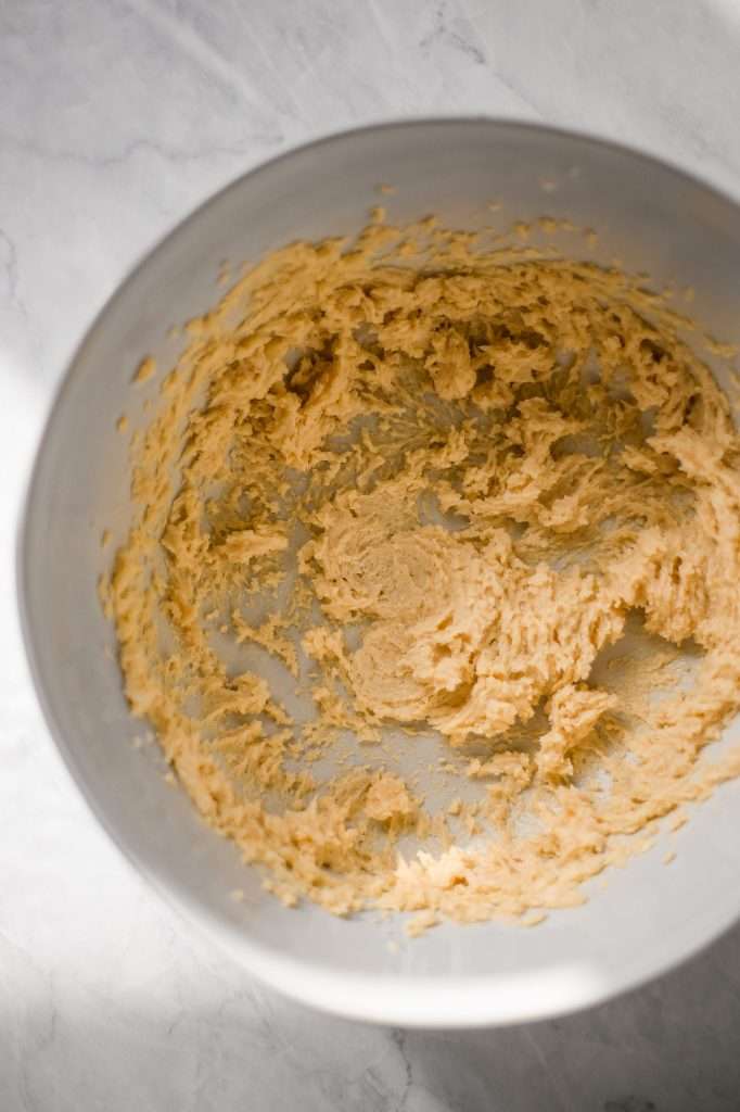 A mixing bowl filled with the ingredients needed for a sourdough loaf. 