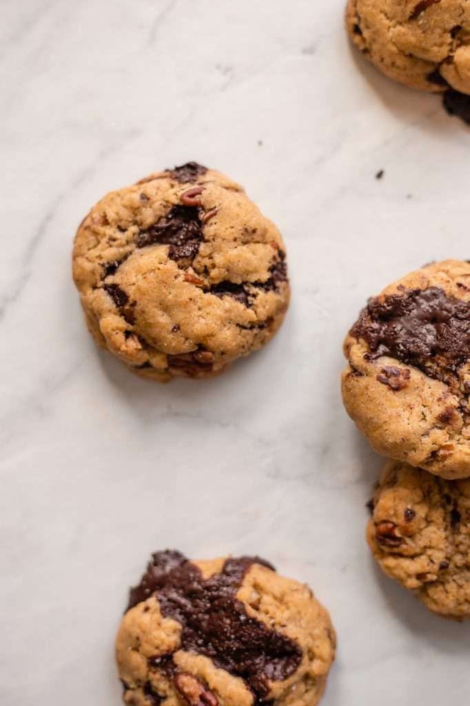 freshly baked sourdough chocolate chip cookies with melty chocolate pieces and pecans. 