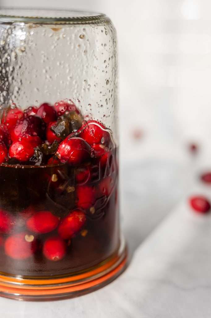 dark red cranberry honey with jalapenos that has started fermenting. The honey is thinner and darker. 