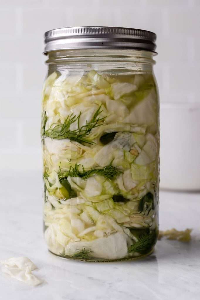 jalapeno sauerkraut in a 32 ounce ball mason jar with a sliver lid. 