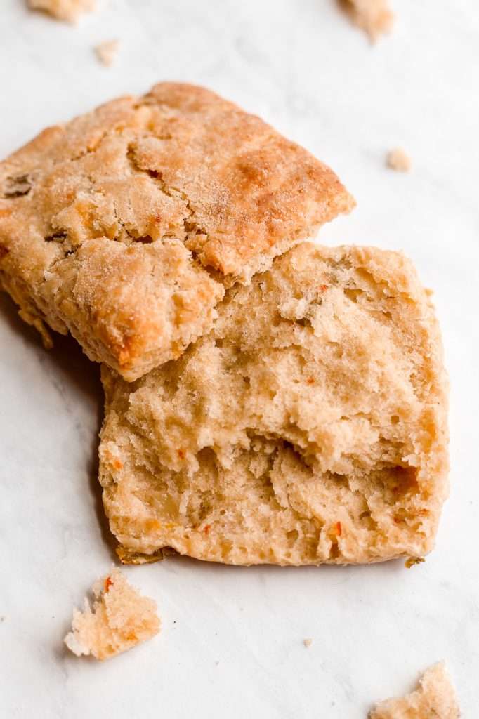 a kimchi cheddar biscuit pulled apart in half to show the inner texture of the biscuit. 