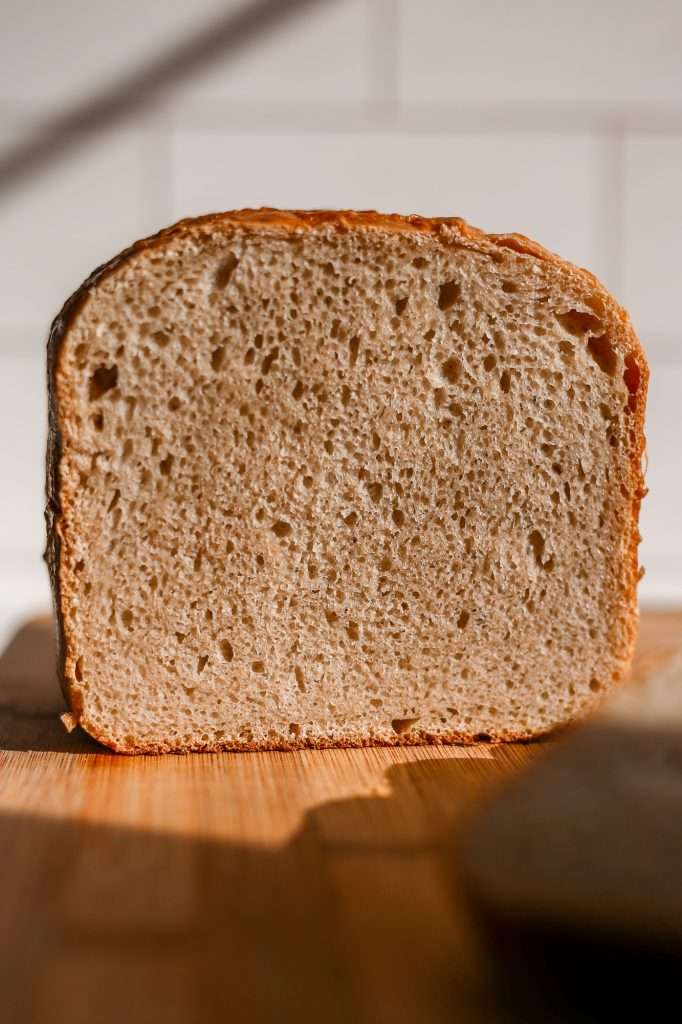 a loaf of sourdough bread machine bread sliced to show the inner texture