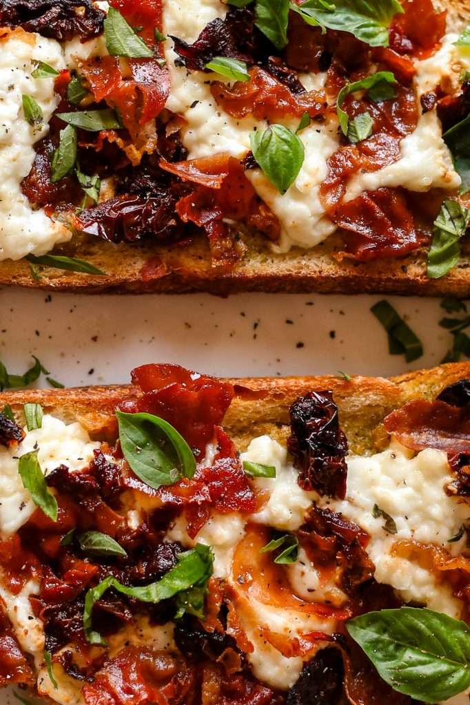 close up of cottage cheese pizza toast showing the melted texture of cottage cheese. 