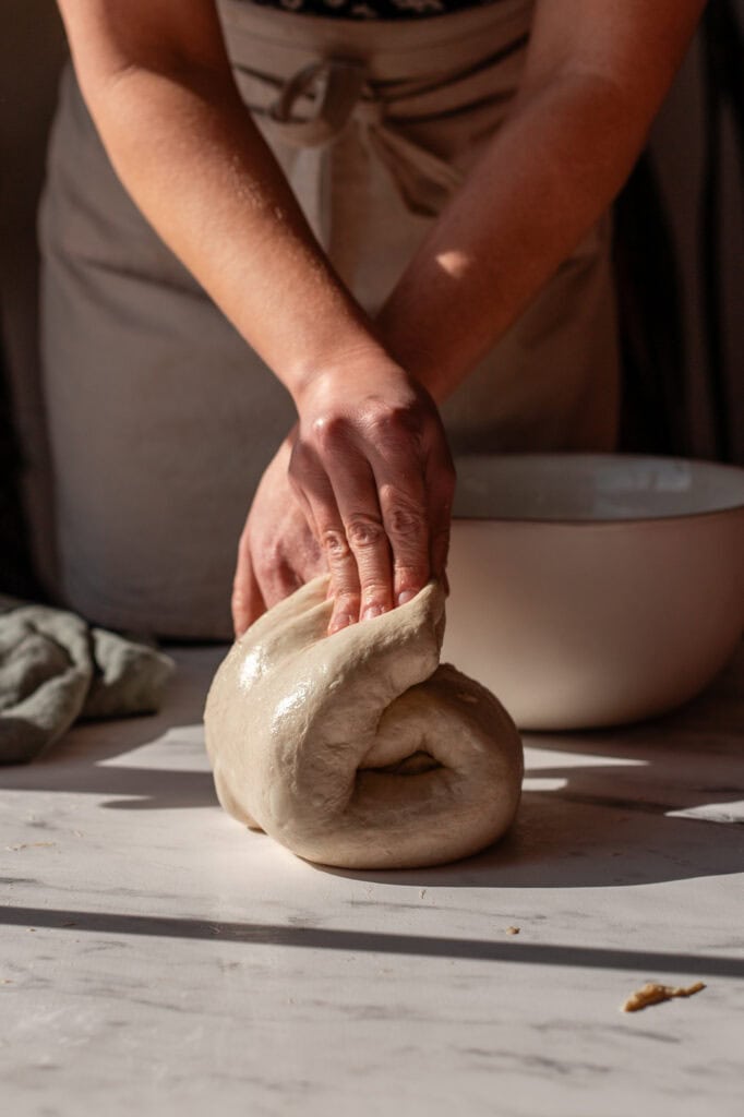 Continuing to fold dough from other side to ensure proper elasticity.