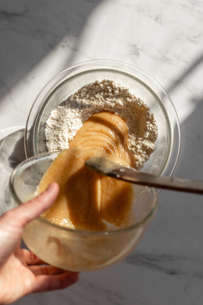 Adding the wet ingredient mix to the flour.