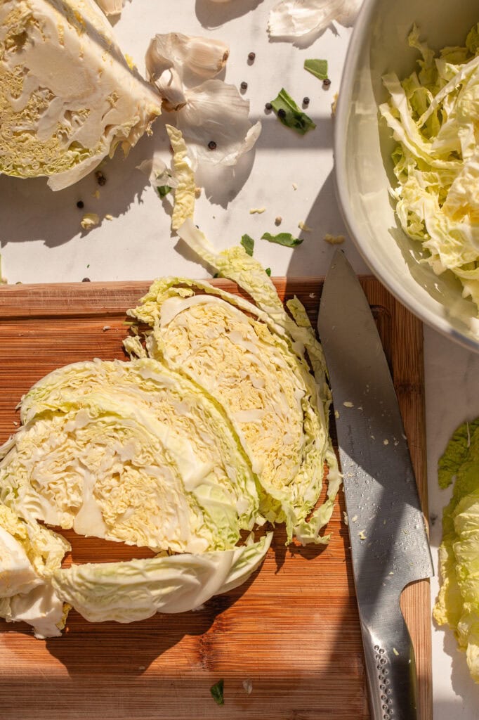 Ingredients for Roasted Garlic Sauerkraut A cutting board with a cabbage on it