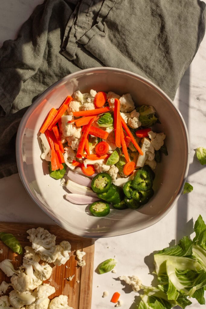 Fermented Giardiniera Raw Ingredients A bowl of vegetables for fermented giardiniera including carrots, celery and onions.