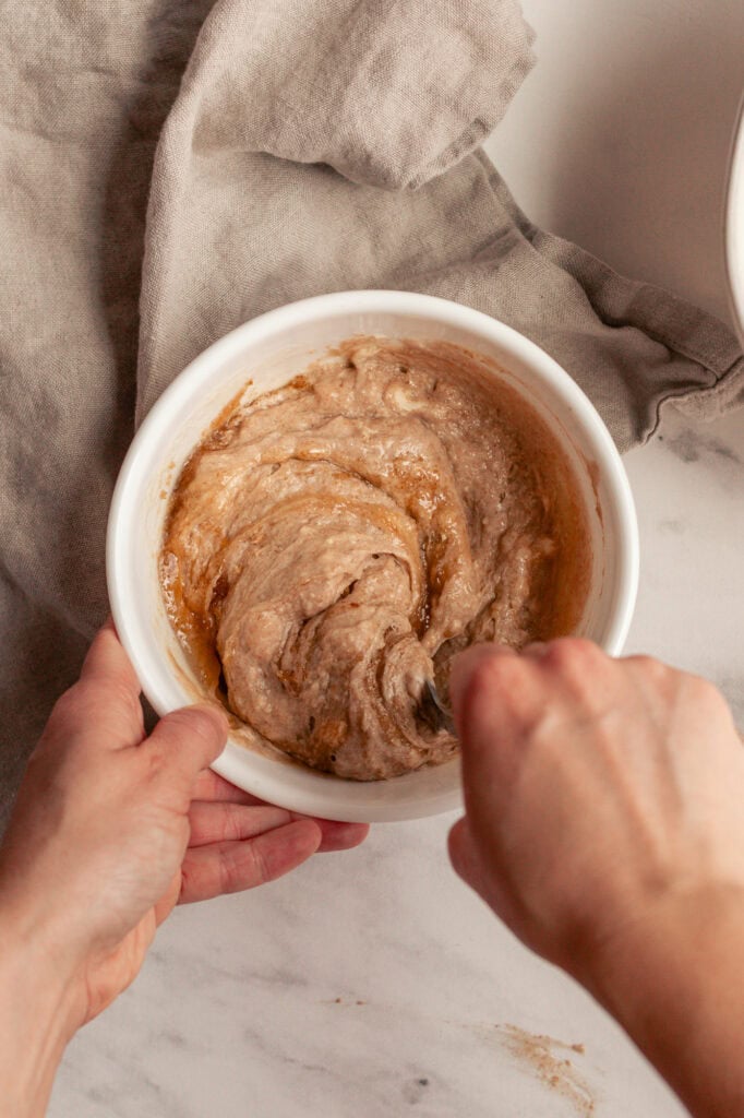 Cobining the wet ingredients The wet ingredients—honey, brown sugar, sourdough starter, and butter—have been creamed together into a smooth, light brown mixture.