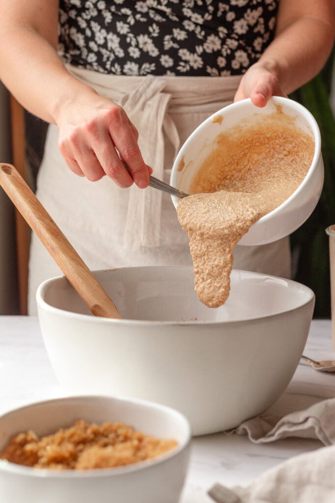Wet ingredient consistency The wet ingredients, including butter, honey, and sourdough starter, have been folded together into a creamy mixture.