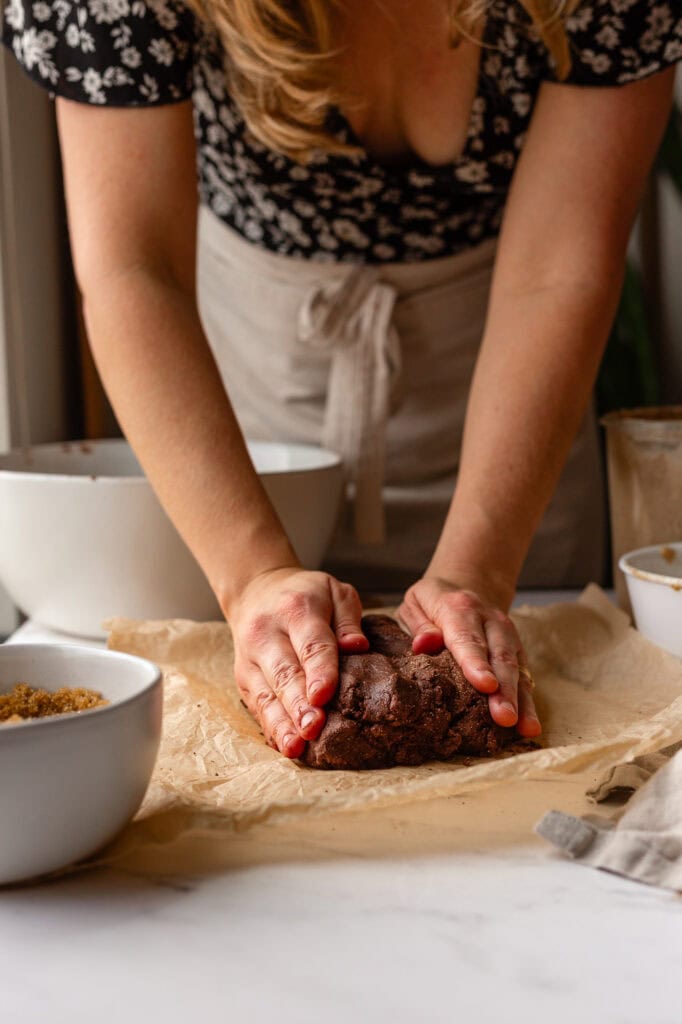 Sourdough Chocolate dough initial shape Hands gently patting and shaping the dough into a rough, rectangular slab.