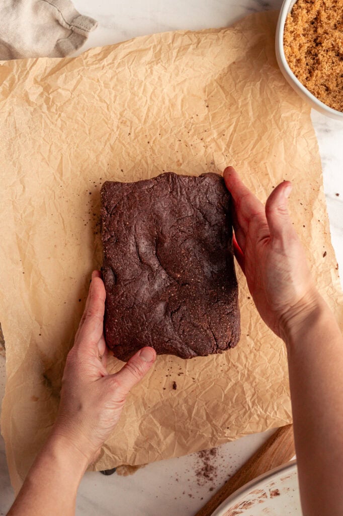 Chocolate Dough Shaped into A Square The dough has been pressed and shaped into a smooth, uniformed rectangular slab, ready for the next step.