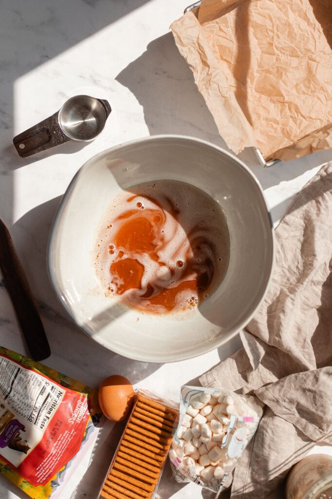 Browned butter being mixed in a bowl.