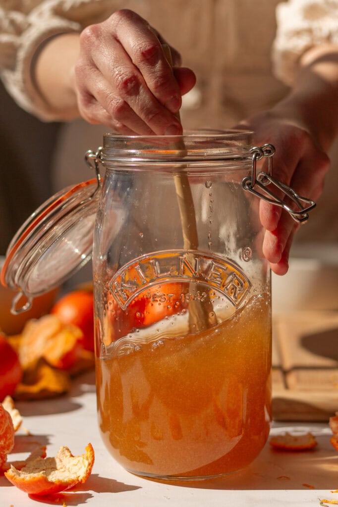 stirring the vinegar and sugar together with a wooden spoon in a 1.5-liter clip top glass jar