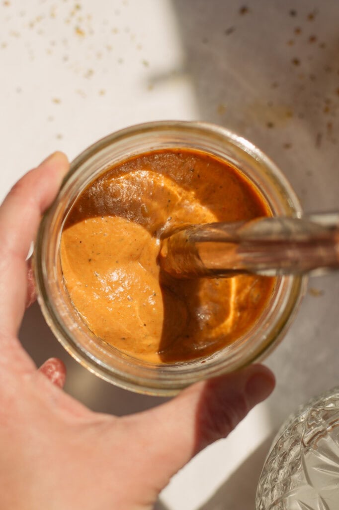 A hand blender blends all the ingredients into a thick mixture.