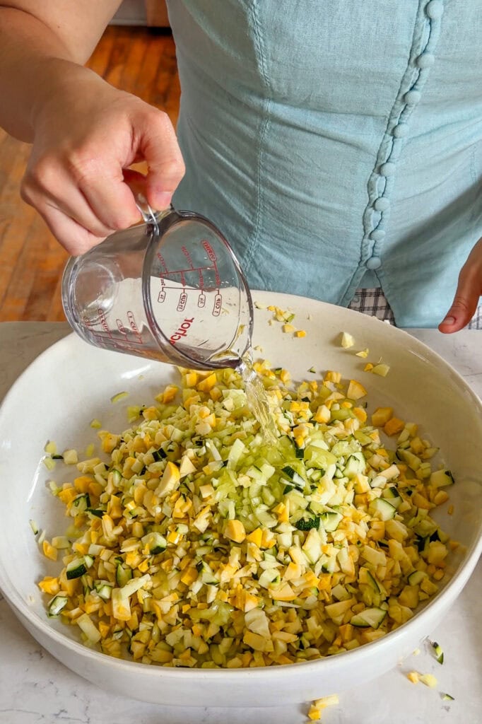 Water being poured into a bowl of raw vegetables